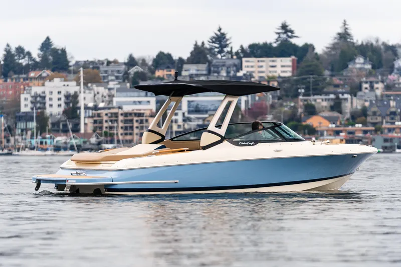 Slide: The Image of 2025 Chris-Craft Sportster 25 boat on water, cityscape background. - 1