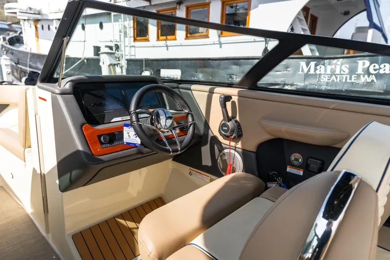 Slide: The Image of 2025 Chris-Craft Sportster 25 boat interior with steering wheel and dashboard, Seattle, WA. - 10