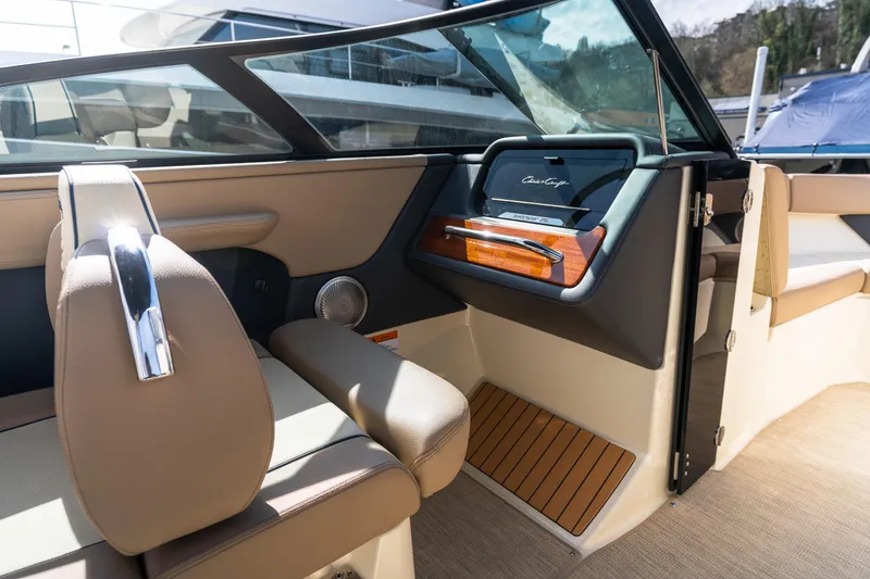 Slide: The Image of 2025 Chris-Craft Sportster 25 interior with luxurious seating and elegant dashboard design. - 12