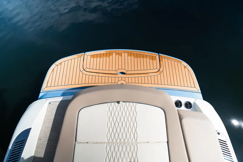 Slide: The Image of 2025 Chris-Craft Sportster 25 boat with elegant teak deck and luxurious seating. - 14