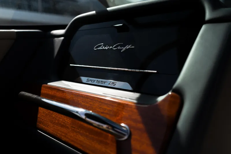 Slide: The Image of Interior detail of 2025 Chris-Craft Sportster 25, featuring elegant wood and chrome accents. - 15