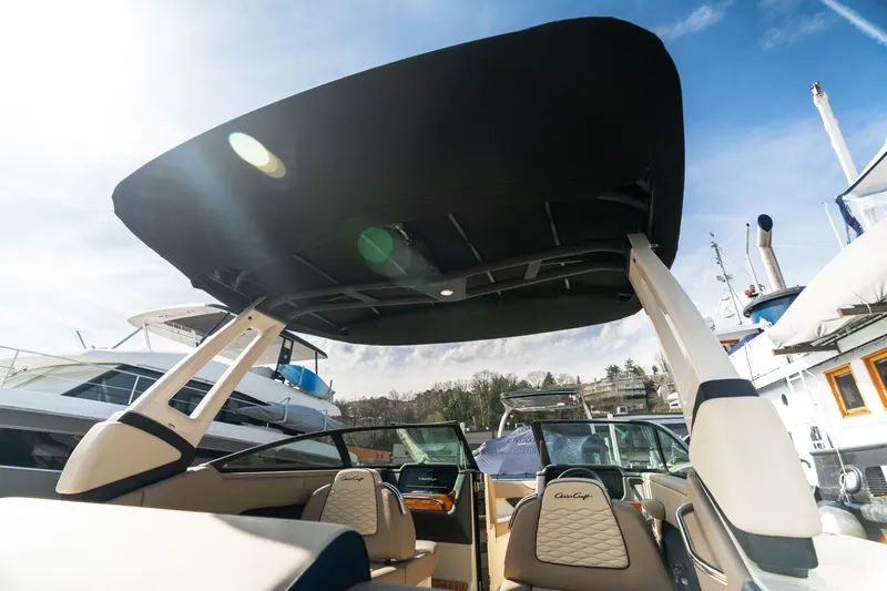 Slide: The Image of 2025 Chris-Craft Sportster 25 boat interior with canopy, showcasing luxury seating and design. - 9