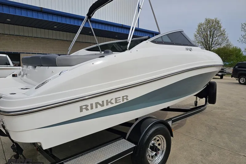 Slide: The Image of 2020 Rinker 19QX BR boat on trailer, parked outdoors. - 12