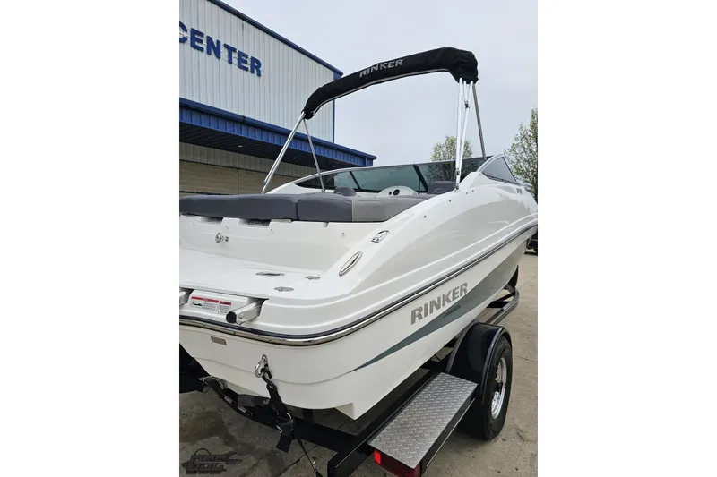 Slide: The Image of 2020 Rinker 19QX BR boat on trailer, parked outside a building. - 14