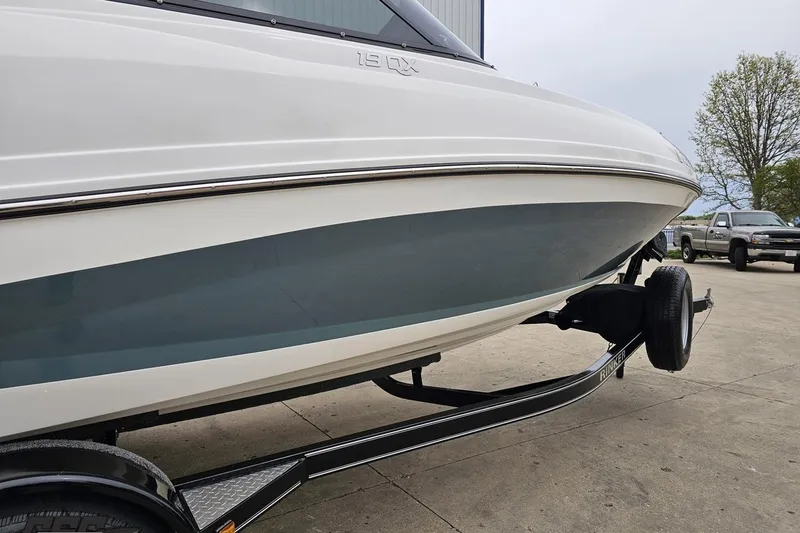 Slide: The Image of 2020 Rinker 19QX BR boat on trailer, parked outdoors. - 15