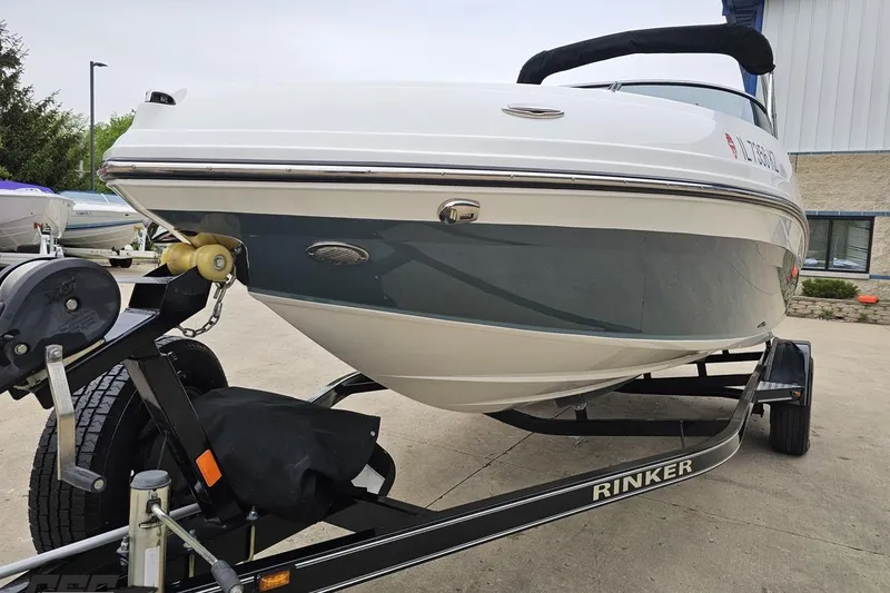 Slide: The Image of 2020 Rinker 19QX BR boat on trailer, parked outdoors near a building. - 26