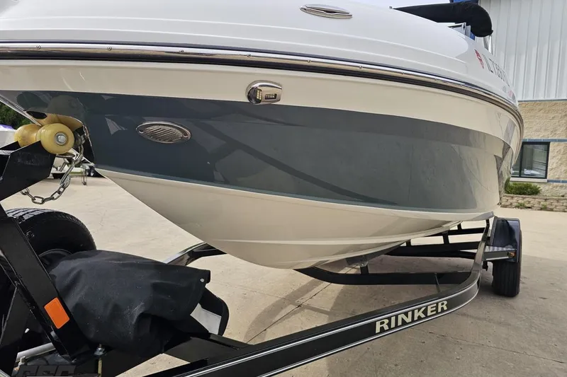 Slide: The Image of 2020 Rinker 19QX BR boat on trailer, close-up view of hull and branding. - 27