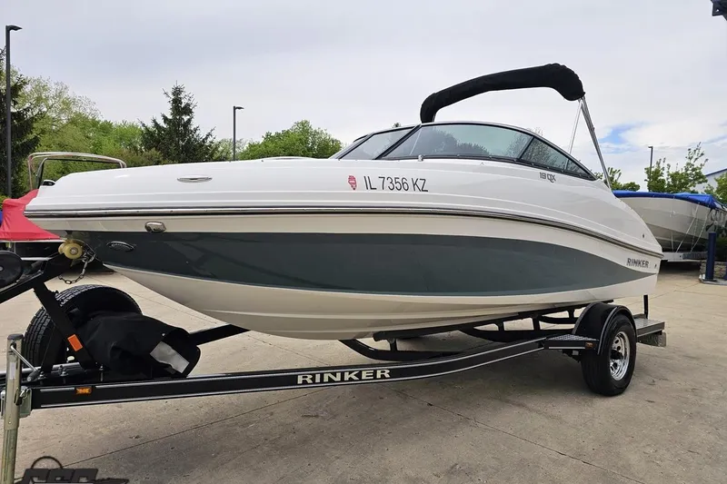 Slide: The Image of 2020 Rinker 19QX BR boat on trailer, parked outdoors. - 28