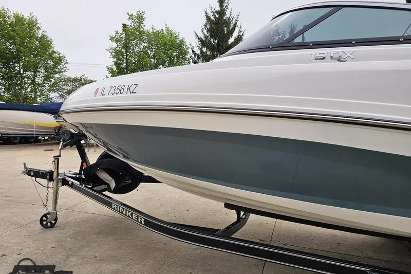 Slide: The Image of 2020 Rinker 19QX BR boat on trailer, parked outdoors. - 31