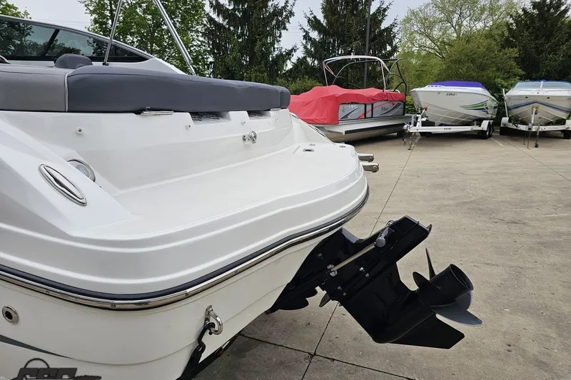 Slide: The Image of 2020 Rinker 19QX BR boat with outboard motor in a marina setting. - 36