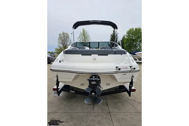 Slide: The Image of 2020 Rinker 19QX BR boat, rear view, on trailer, with canopy and outboard motor. - 37