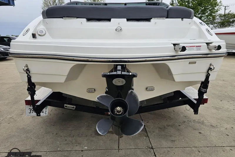 Slide: The Image of Rear view of a 2020 Rinker 19QX BR boat on a trailer, showcasing the propeller. - 39