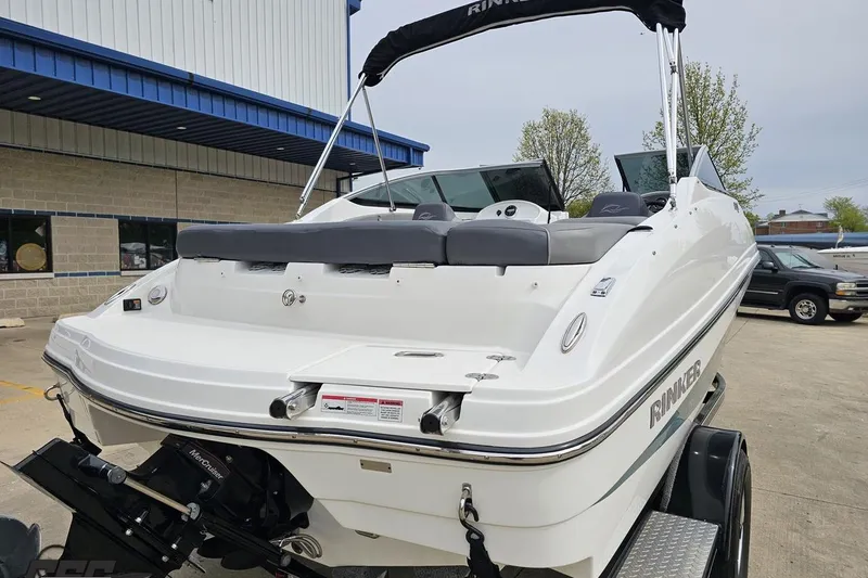 Slide: The Image of 2020 Rinker 19QX BR boat on trailer, parked outdoors near a building. - 40