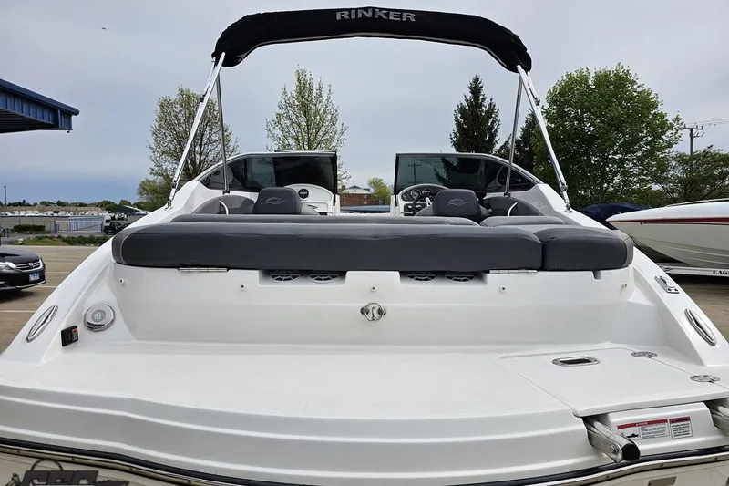 Slide: The Image of 2020 Rinker 19QX BR boat with sleek design, rear seating, and canopy in a marina setting. - 41
