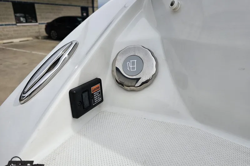 Slide: The Image of Fuel cap and warning label on a 2020 Rinker 19QX BR boat. - 43