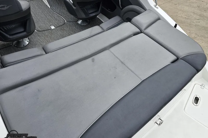 Slide: The Image of 2020 Rinker 19QX BR boat interior with gray cushioned seating and carpeted flooring. - 46