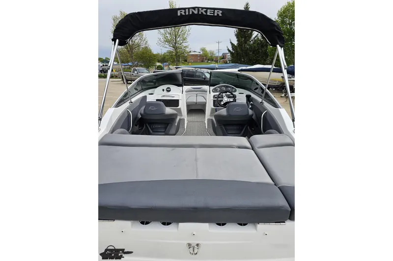 Slide: The Image of 2020 Rinker 19QX BR boat interior with seating and steering wheel, featuring a black canopy. - 47