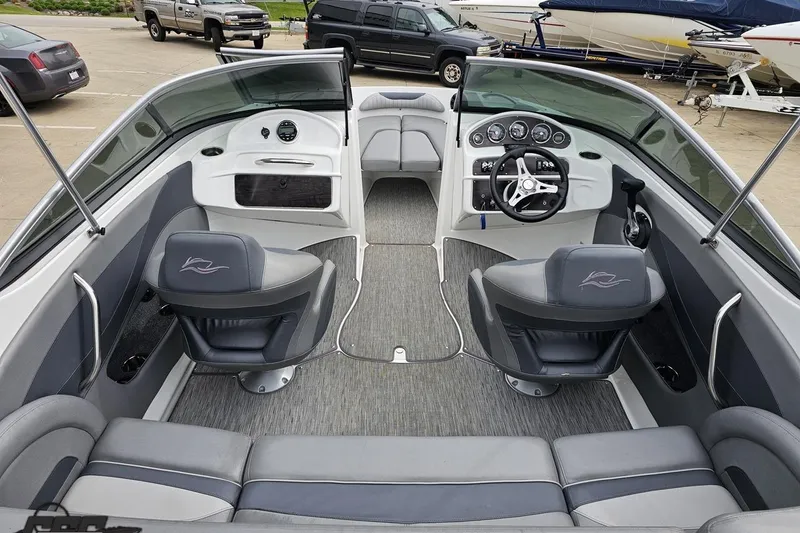 Slide: The Image of 2020 Rinker 19QX BR boat interior with gray seating and modern dashboard. - 52