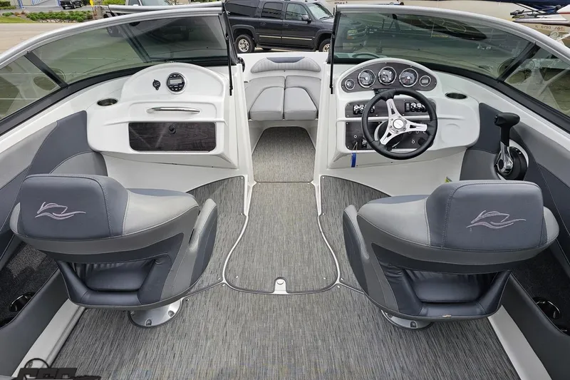 Slide: The Image of 2020 Rinker 19QX BR boat interior with gray seating and modern dashboard. - 53