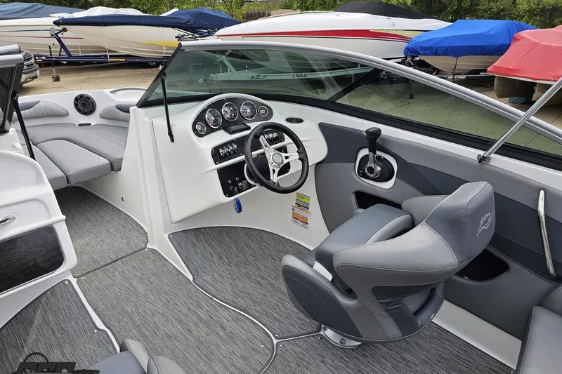Slide: The Image of 2020 Rinker 19QX BR boat interior with modern dashboard and seating. - 56
