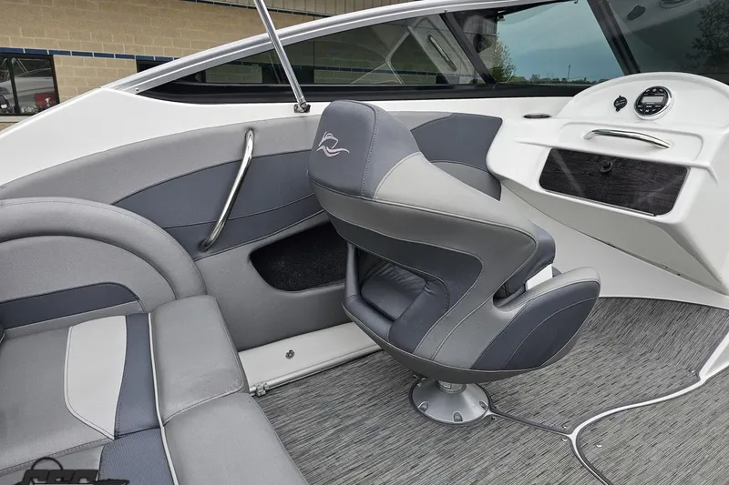 Slide: The Image of 2020 Rinker 19QX BR boat interior with gray seating and modern dashboard design. - 59