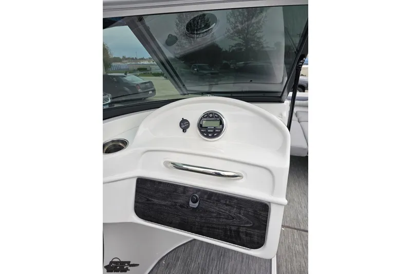 Slide: The Image of 2020 Rinker 19QX BR boat dashboard with modern controls and sleek design. - 61