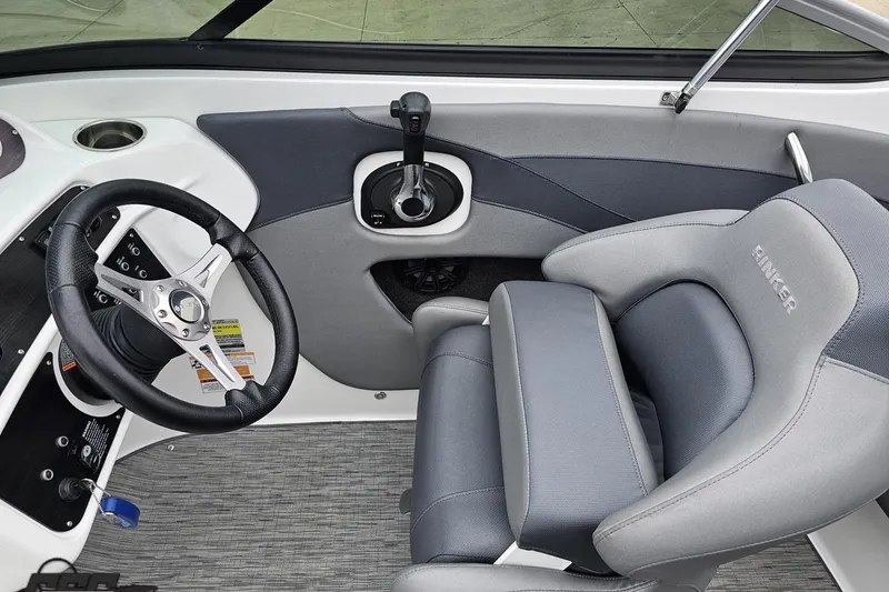 Slide: The Image of 2020 Rinker 19QX BR boat interior with steering wheel and comfortable seating. - 64