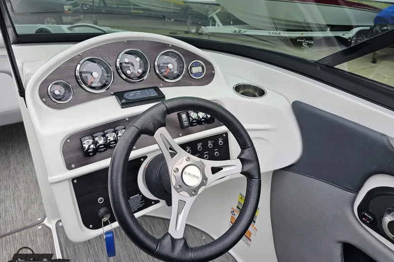 Slide: The Image of 2020 Rinker 19QX BR boat dashboard with steering wheel and instrument panel. - 66