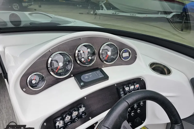 Slide: The Image of Dashboard of a 2020 Rinker 19QX BR boat with gauges and controls. - 67