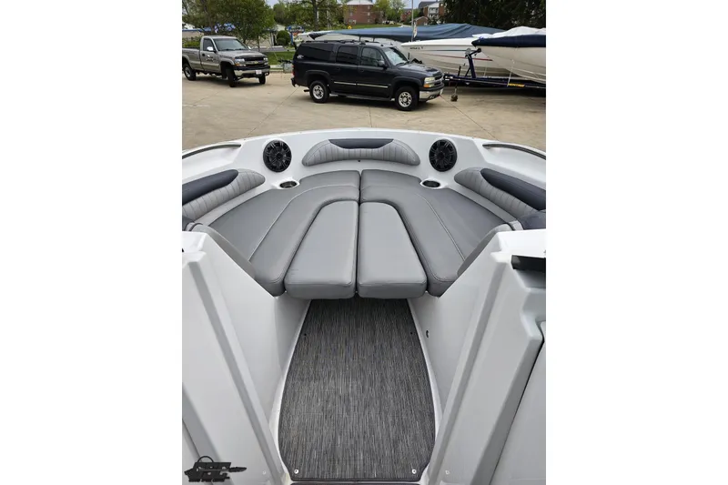 Slide: The Image of 2020 Rinker 19QX BR boat interior with gray seating and speakers. - 70