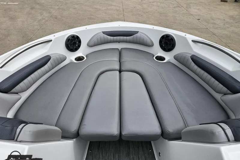Slide: The Image of 2020 Rinker 19QX BR boat interior with gray cushioned seating and built-in speakers. - 71