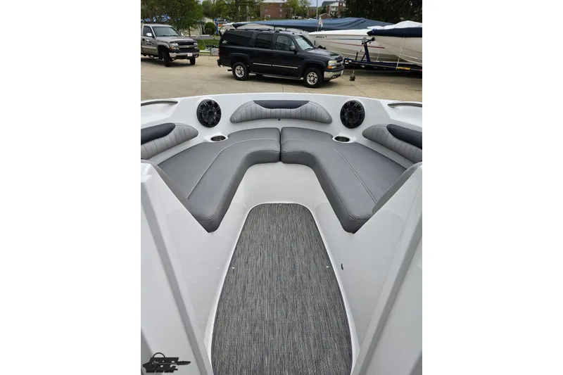 Slide: The Image of 2020 Rinker 19QX BR boat interior with gray seating and speakers. - 73
