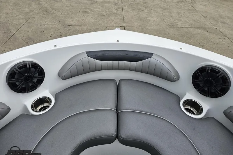 Slide: The Image of 2020 Rinker 19QX BR boat interior with gray seating, speakers, and cup holders. - 77