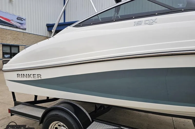 Slide: The Image of 2020 Rinker 19QX BR boat on trailer, side view near building. - 8