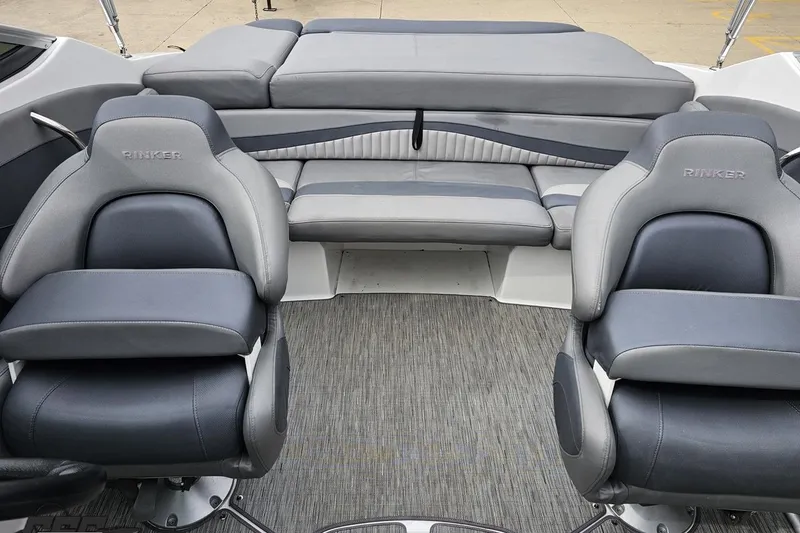 Slide: The Image of 2020 Rinker 19QX BR boat interior with gray seating and carpeted flooring. - 81