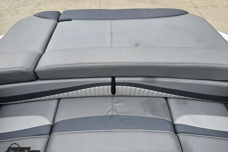 Slide: The Image of 2020 Rinker 19QX BR boat interior with gray cushioned seating. - 84