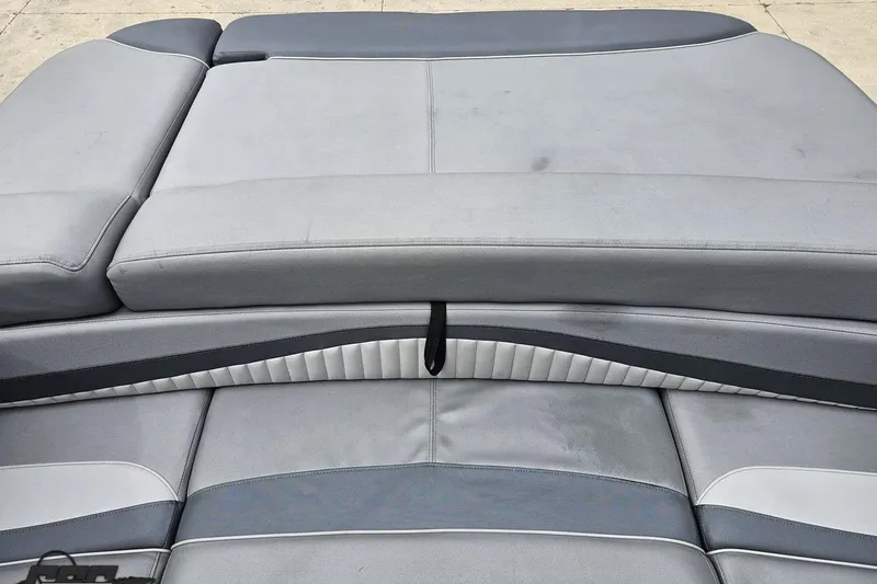 Slide: The Image of 2020 Rinker 19QX BR boat interior with gray cushioned seating. - 85