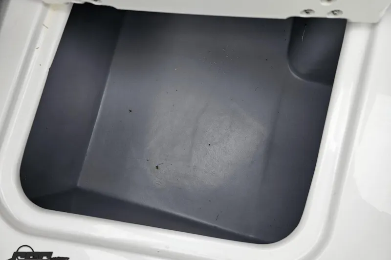 Slide: The Image of Storage compartment of a 2020 Rinker 19QX BR boat, featuring a clean interior. - 89