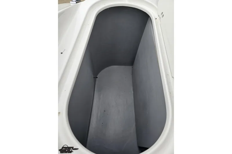 Slide: The Image of Storage compartment of 2020 Rinker 19QX BR boat, featuring a spacious interior. - 90