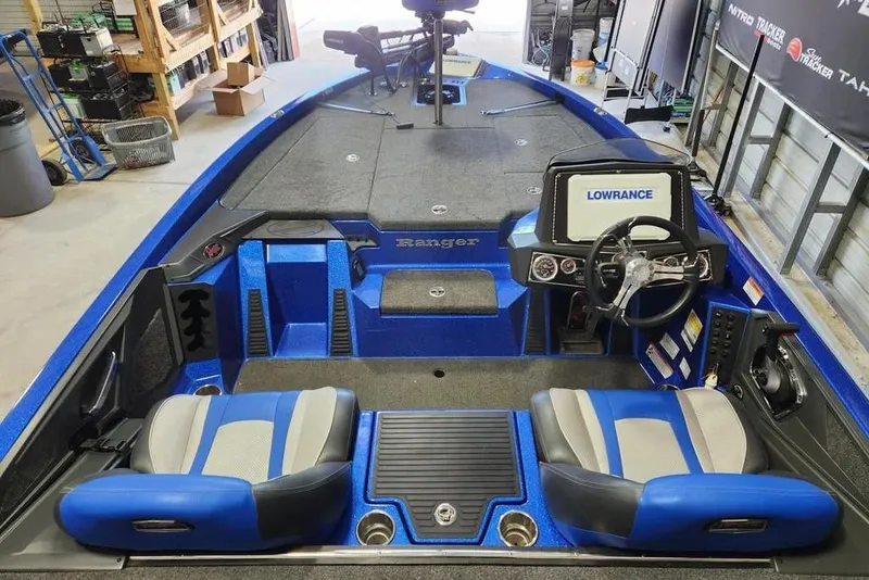 Slide: The Image of 2022 Ranger Z519 Cup-Equipped boat interior with blue seats and Lowrance electronics. - 2