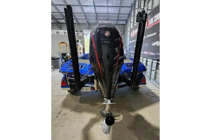 Slide: The Image of 2022 Ranger Z519 Cup-Equipped boat in a garage, showcasing powerful outboard motor. - 3