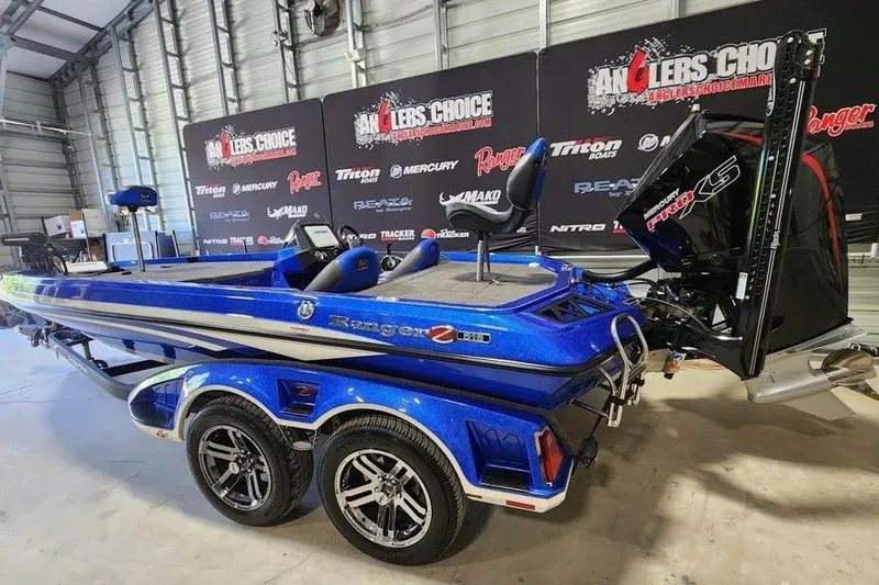 Slide: The Image of 2022 Ranger Z519 Cup-Equipped boat in showroom, featuring sleek blue design and powerful engine. - 5