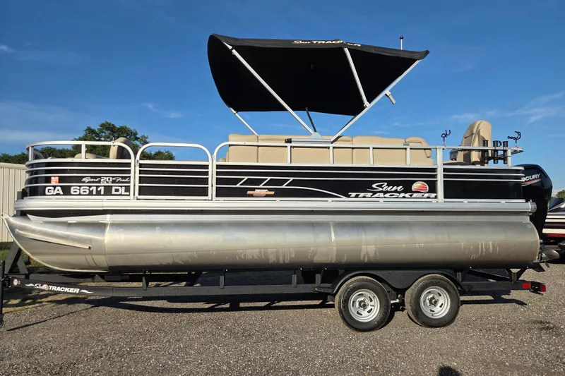 The Image of 2023 Sun Tracker SportFish 20 DLX pontoon boat on trailer, side view. - 0