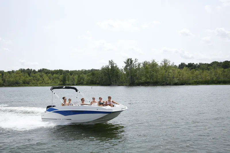 Slide: The Image of A 2027 Starcraft 171SVXOB boat cruising on a calm lake with several people on board. - 1