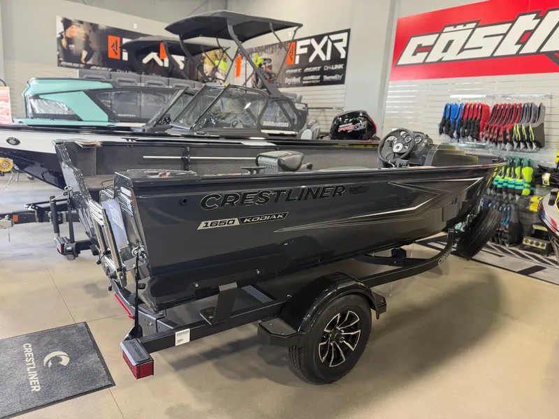 Slide: The Image of 2026 Crestliner 1650 Kodiak SC boat in showroom. - 2