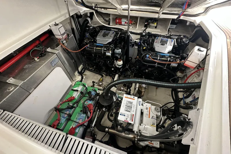 Slide: The Image of Engine compartment of a 2009 Sea Ray Sundancer 310, showcasing dual engines and battery setup. - 21