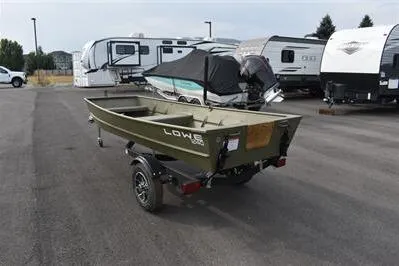 Slide: The Image of 2025 Lowe L1240 Jon boat on trailer, parked near RVs in a lot. - 2