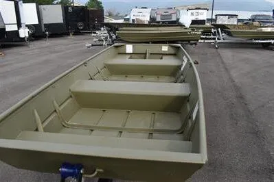 Slide: The Image of 2025 Lowe L1240 Jon boat in a parking lot with trailers in the background. - 4