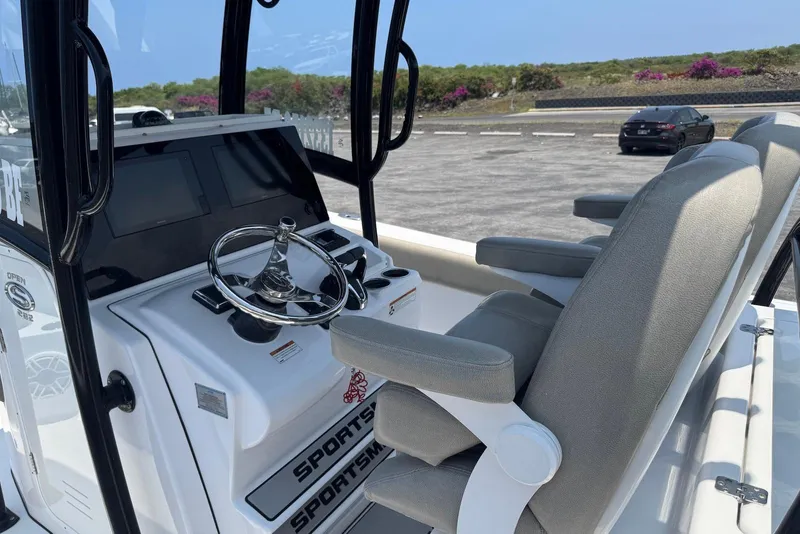 Slide: The Image of 2021 Sportsman Open 282 Center Console boat interior with steering wheel and seating. - 13