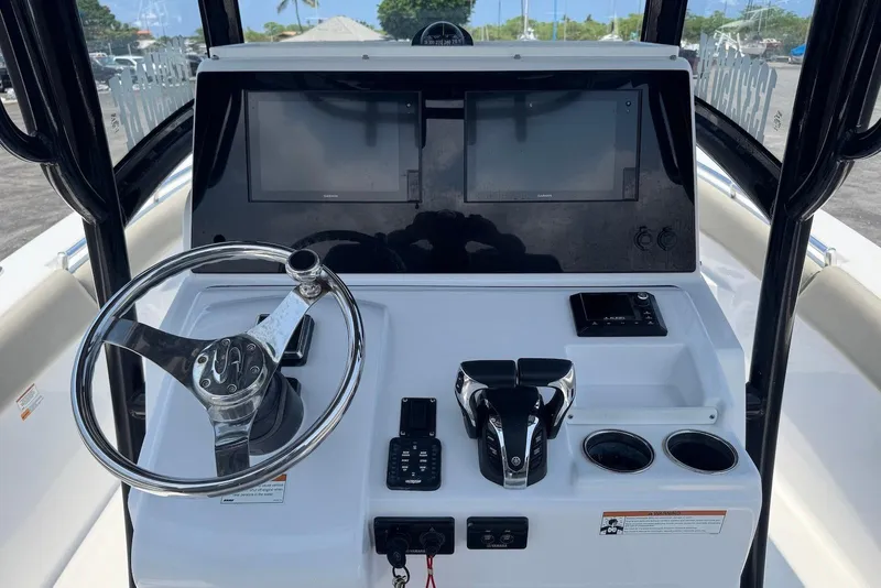 Slide: The Image of 2021 Sportsman Open 282 Center Console dashboard with steering wheel and dual screens. - 14